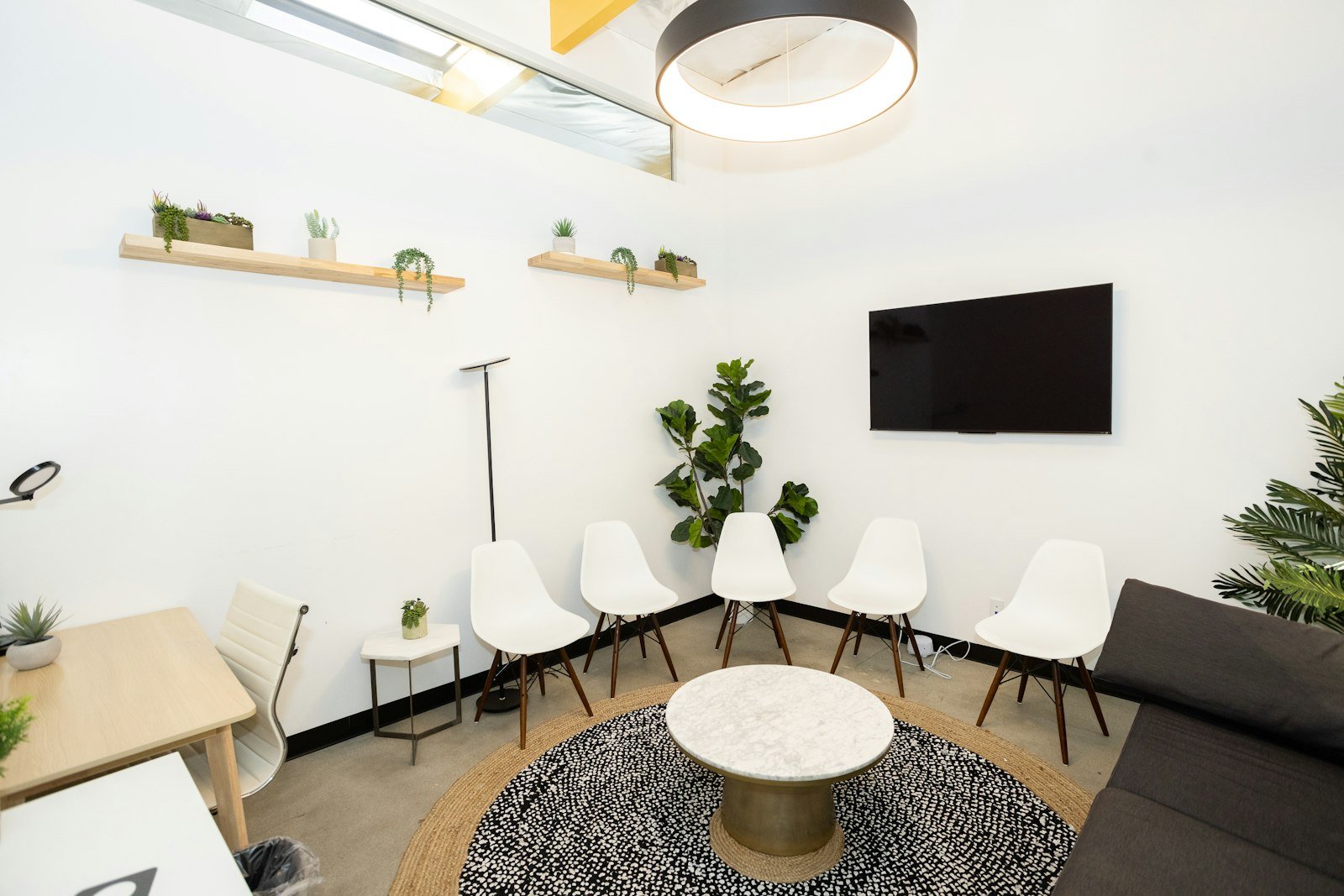Bright, modern waiting room with plants at a mental health counseling clinic