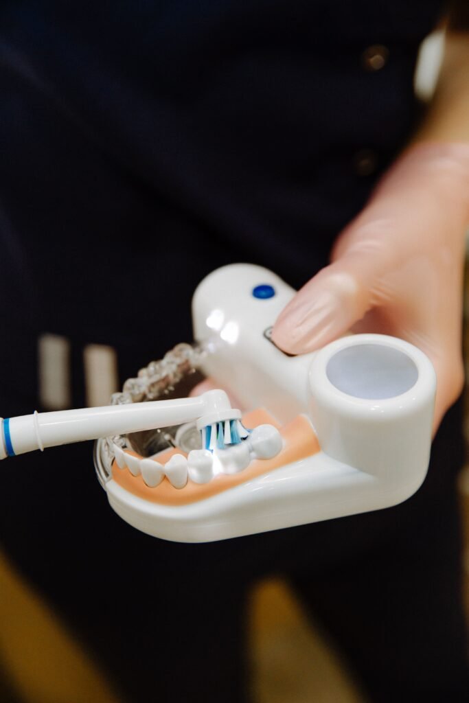 Dentist demonstrating proper toothbrushing technique
