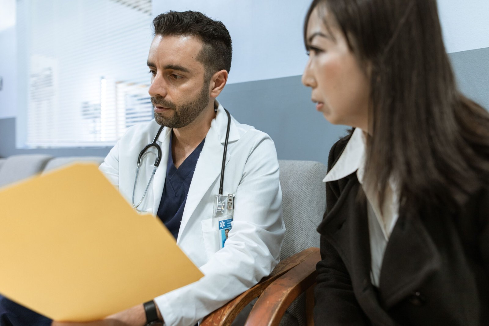 Doctor reviewing symptoms with a male patient during a consultation