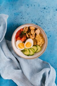 Bowl of vegetables, grains, and eggs representing a heart-healthy diet