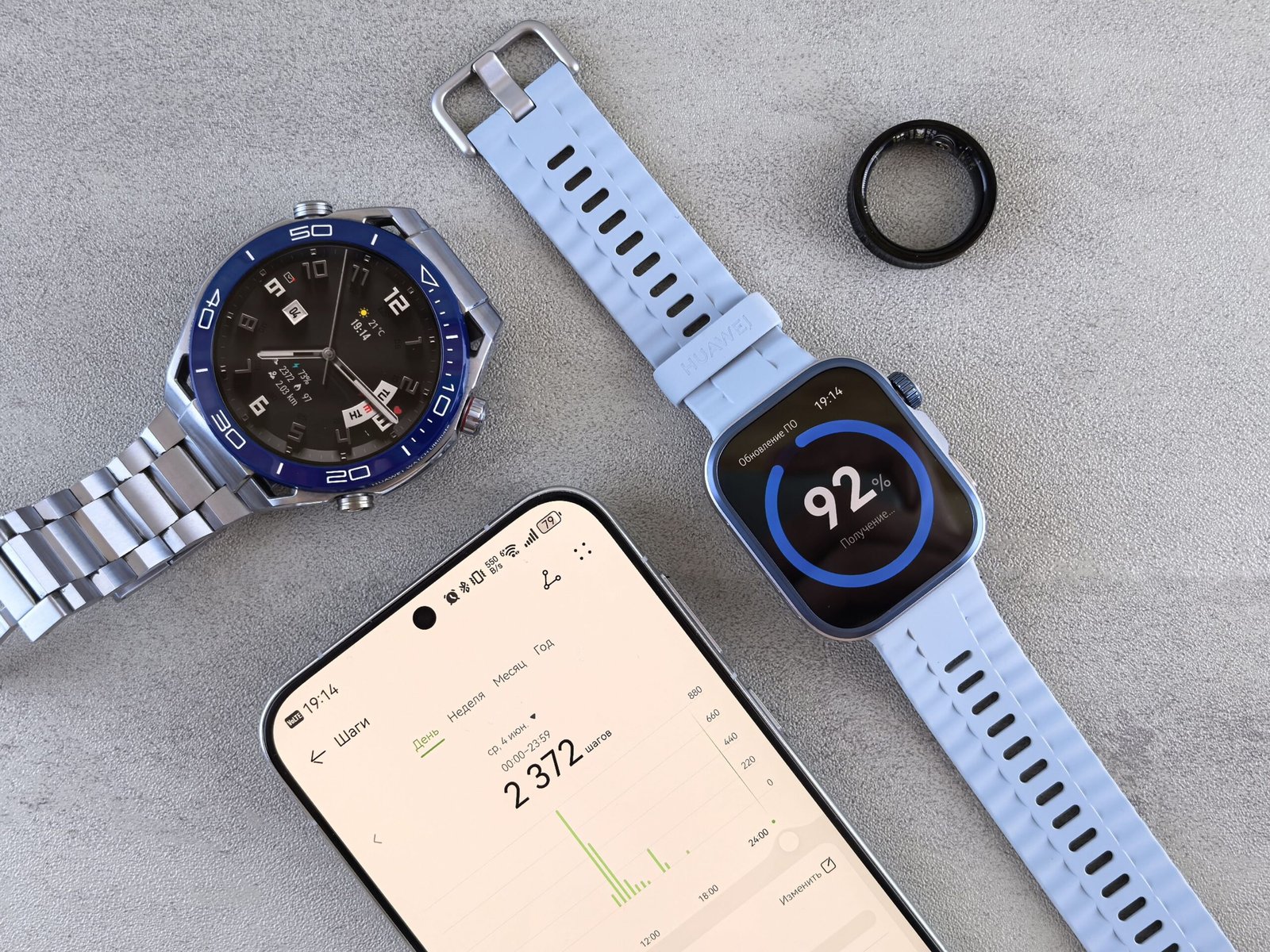 Smartwatch, ring tracker, and smartphone displaying fitness and health data