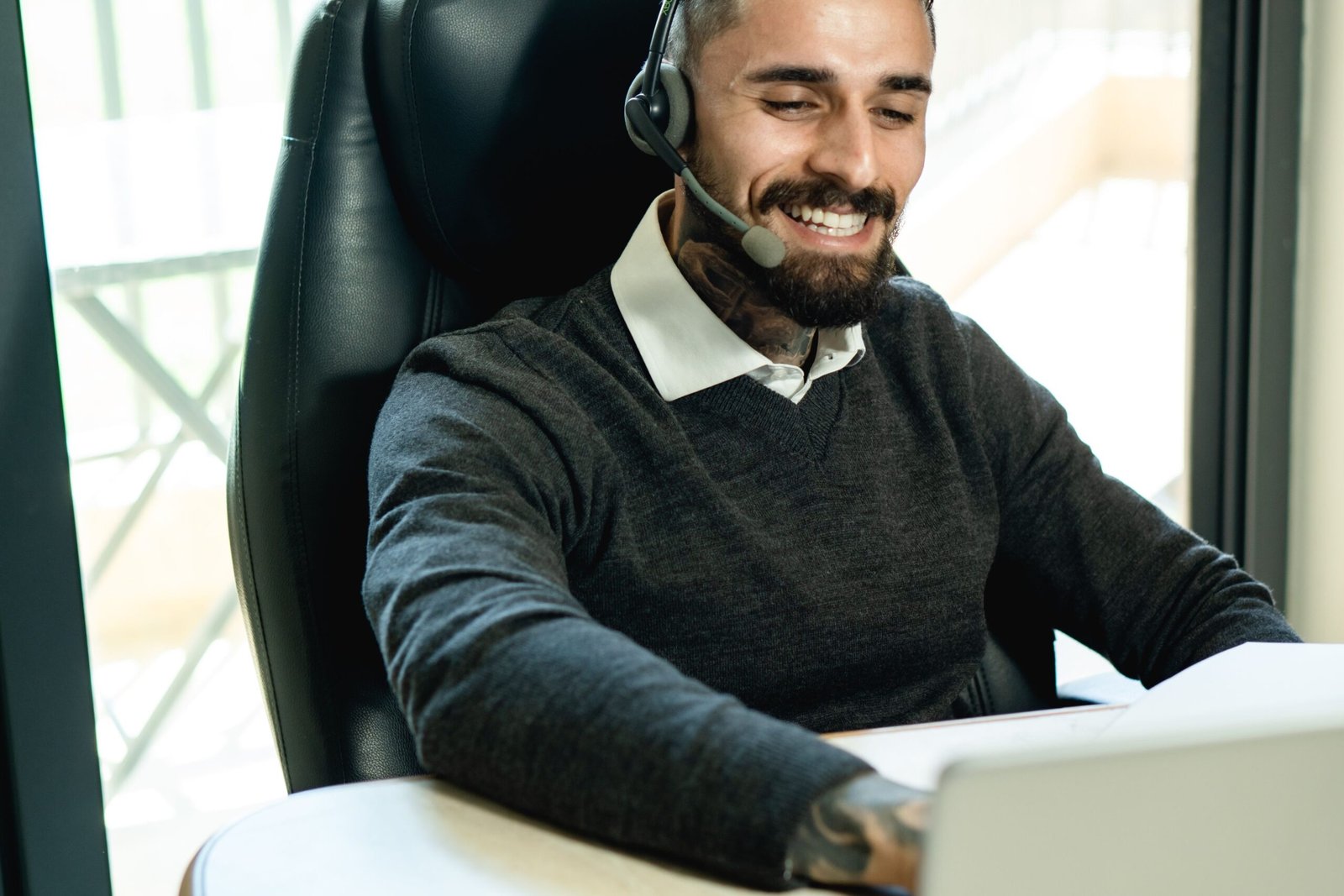 Man wearing a headset while concentrating at his office desk
