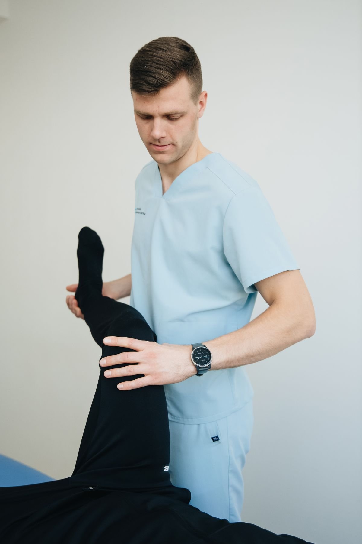 physical therapist assisting a patient with guided rehabilitation exercises