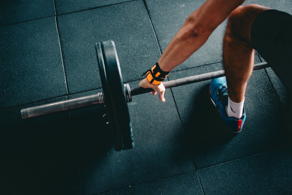 Man gripping a barbell, showing the grip strength engaged during bench press