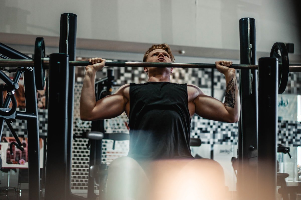 Man lifting a loaded barbell for a decline bench press