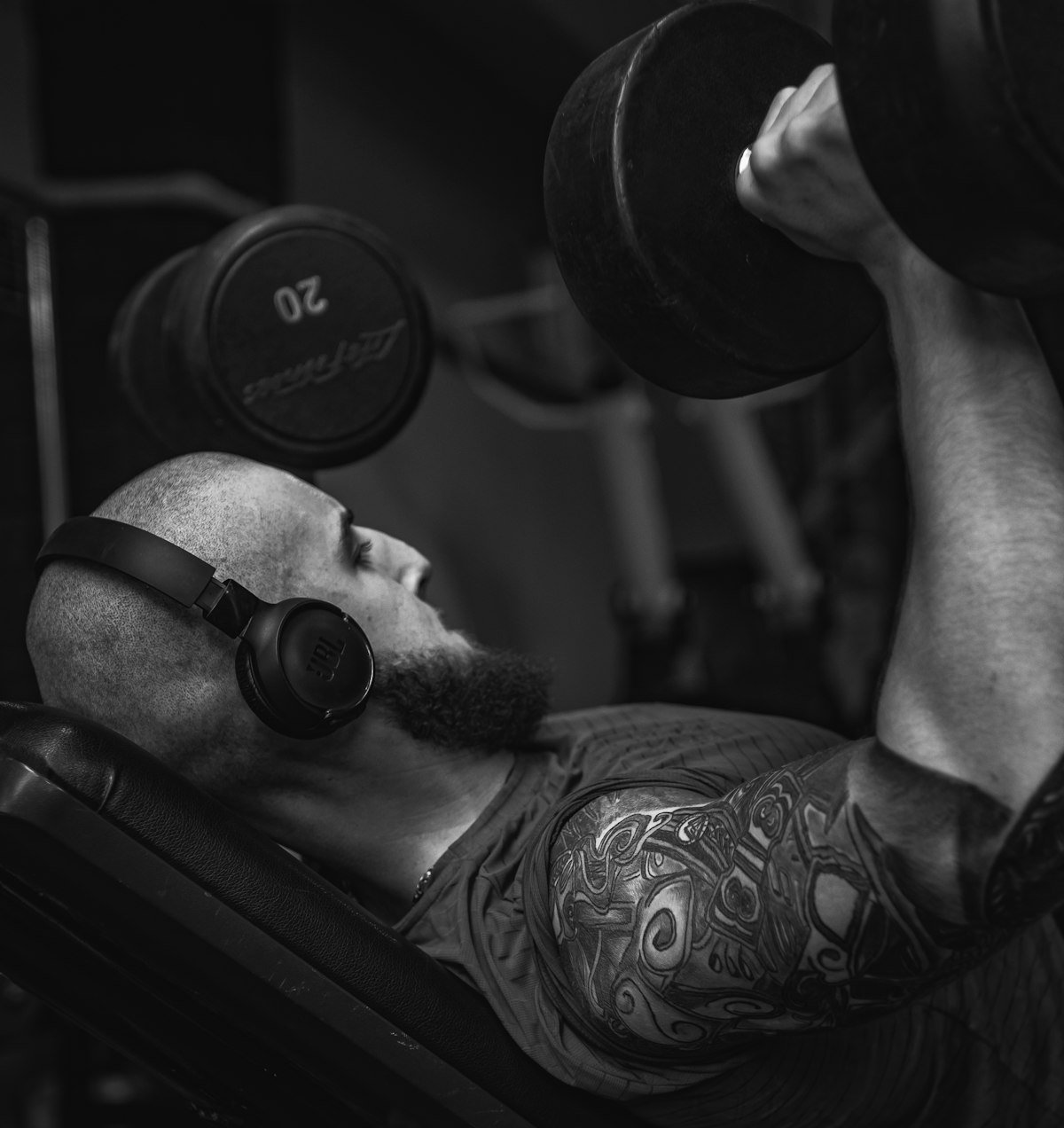 Man performing a barbell decline bench press in a gym