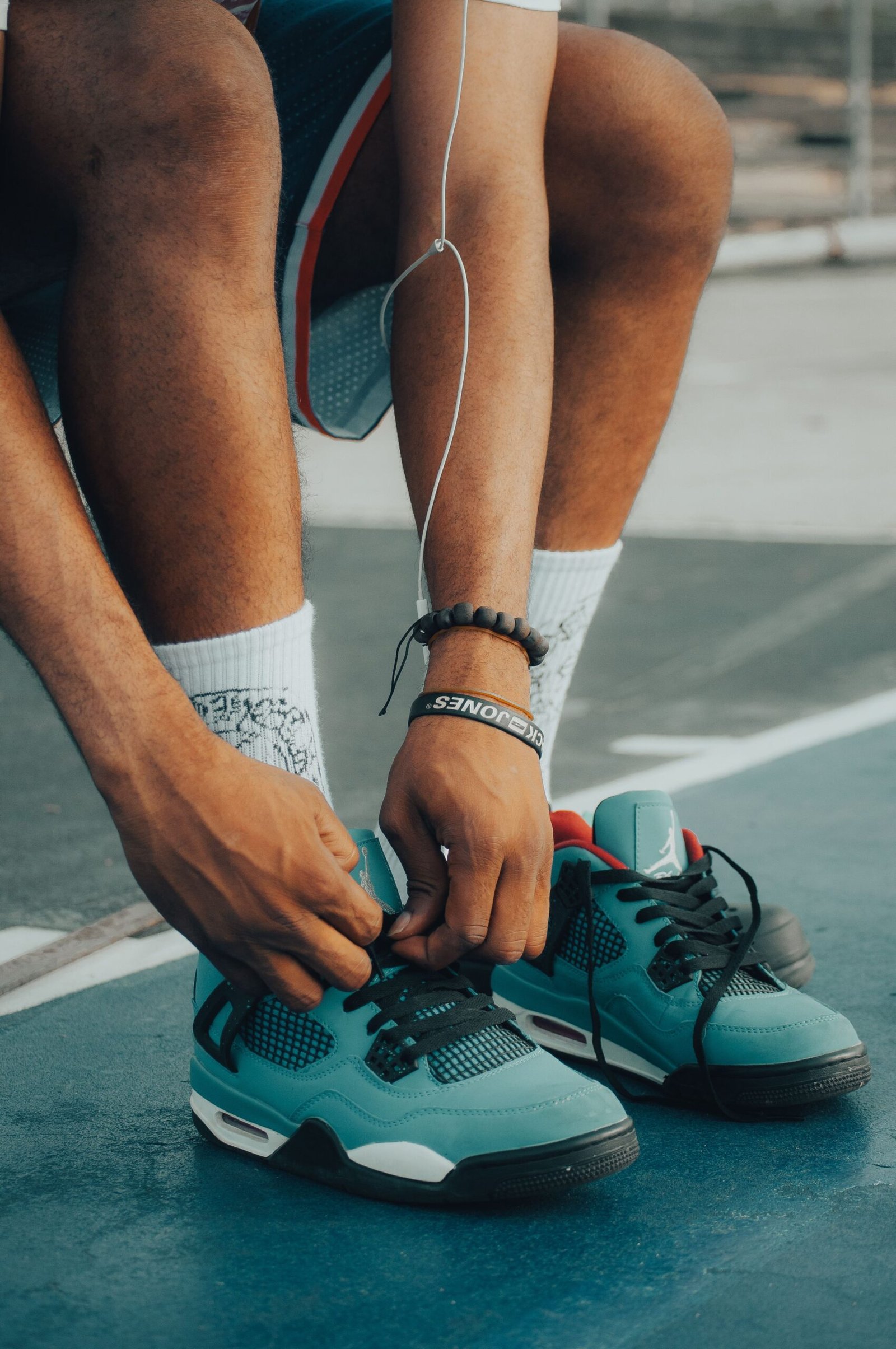 tying athletic shoe laces over an ankle brace