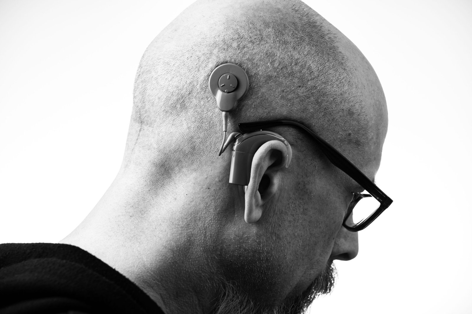 man wearing a behind-the-ear hearing aid