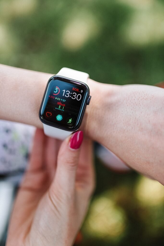 close up of a fitness tracker smartwatch on a wrist showing health metrics