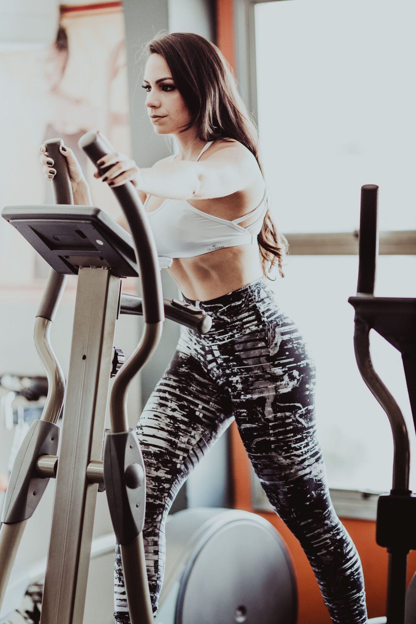 woman exercising on an elliptical trainer indoors
