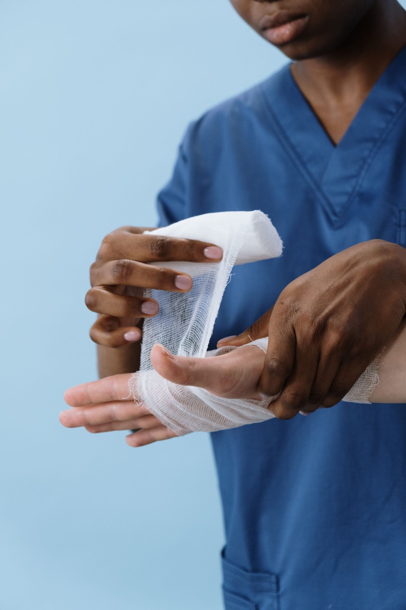 A person getting their sprained wrist checked and cared for