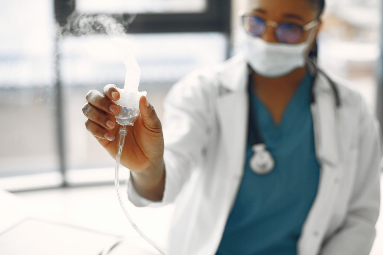 close-up of a healthcare professional holding a nebulizer