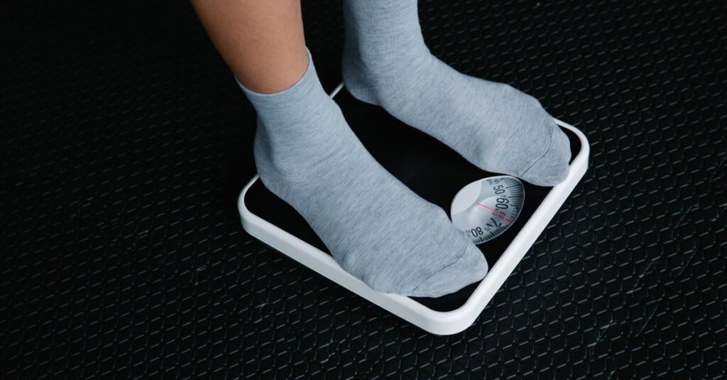 close up of feet standing on a digital body weight scale