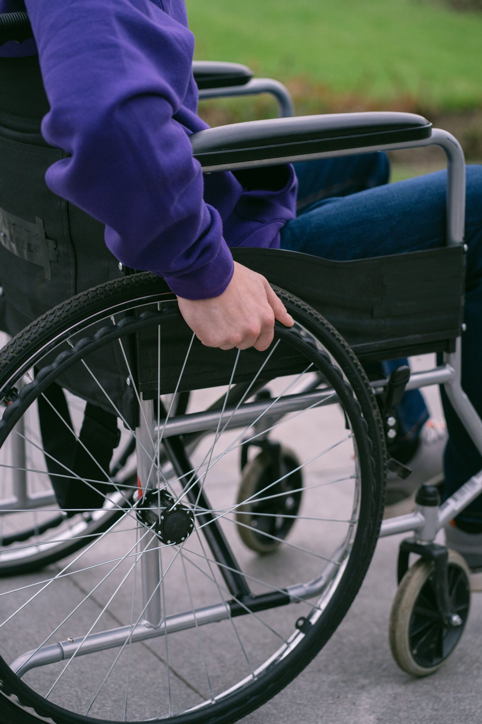 close-up of a person seated in a wheelchair ready for transfer