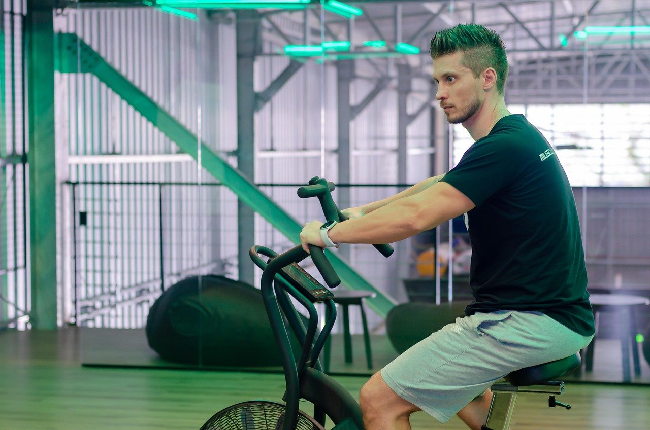 A stationary cardio machine set up in a home gym