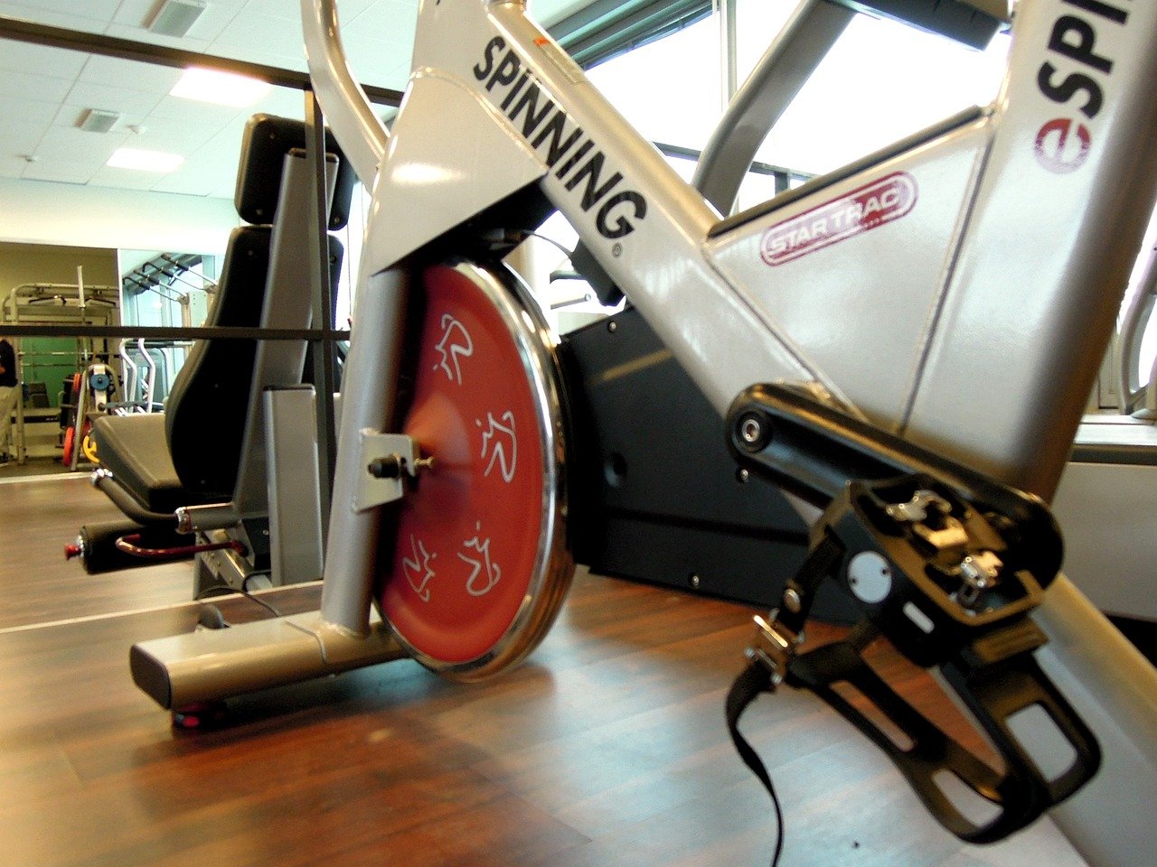 Group indoor cycling class pedaling at high intensity in a fitness studio