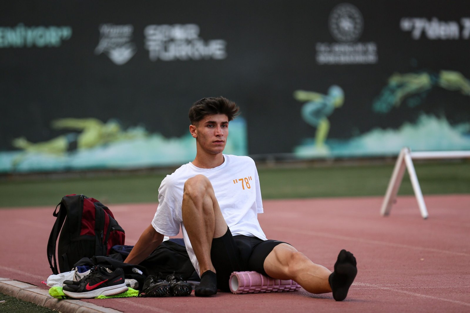 Athlete massaging sore leg muscles after training