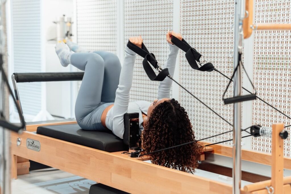 Woman using a Pilates tower for an advanced exercise