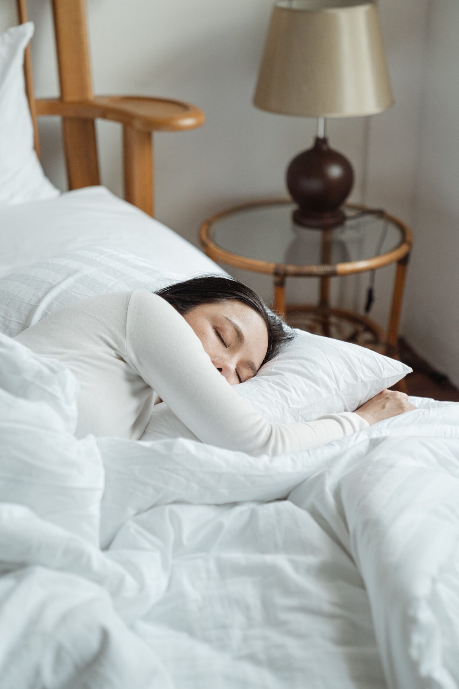 Woman resting in bed after an evening magnesium spray routine