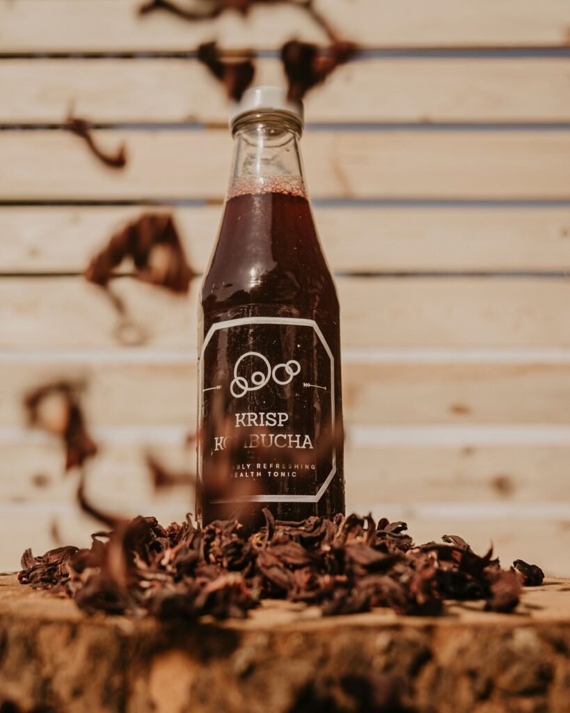 Bottle of kombucha, a fermented probiotic rich beverage, on a wooden surface