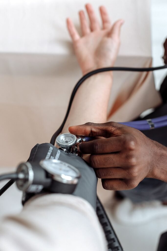 person checking the blood pressure of a patient