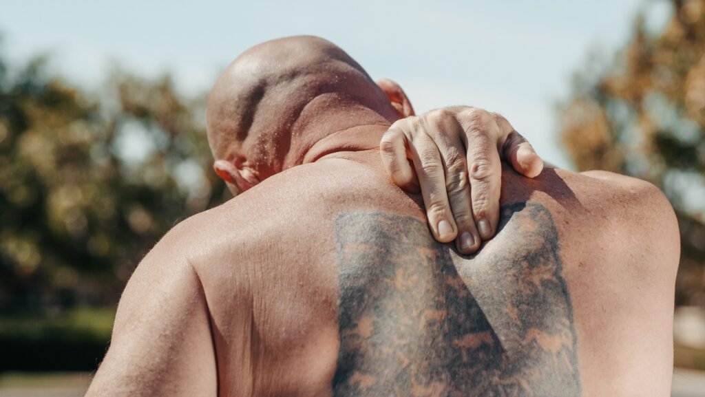 man holding his back in pain