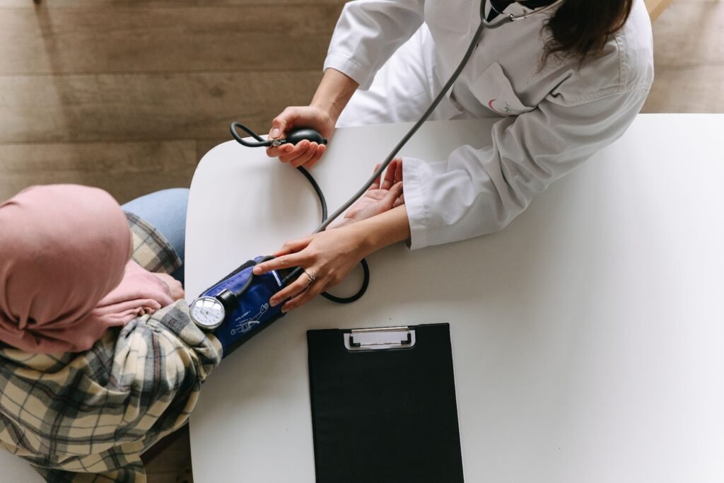 doctor taking the blood pressure of a patient