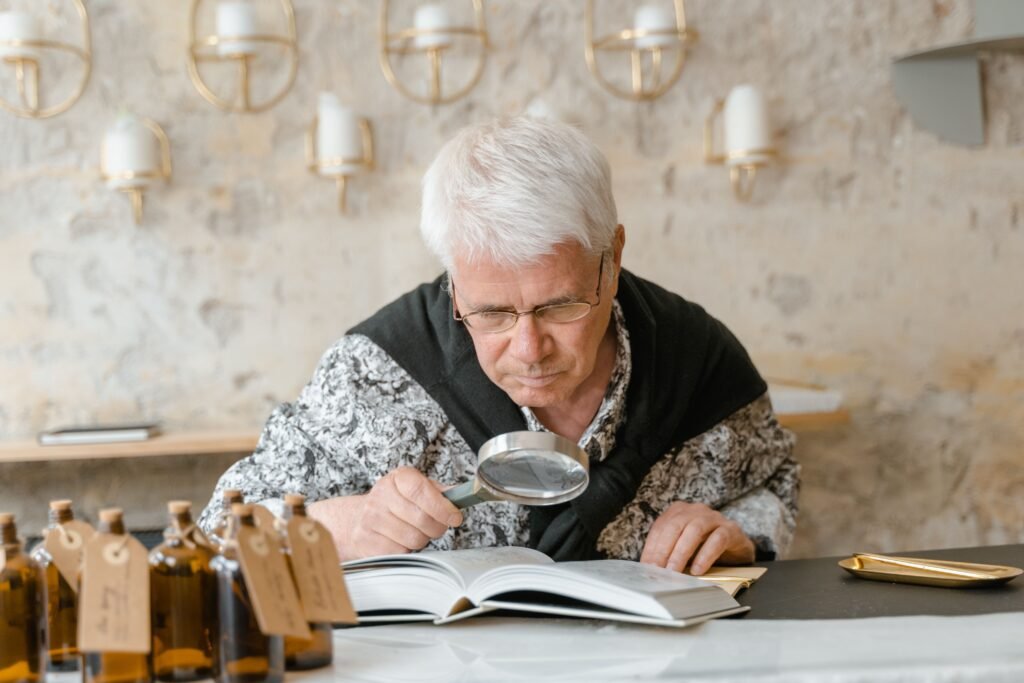 Person using a handheld magnifying glass as a low vision aid to read printed text