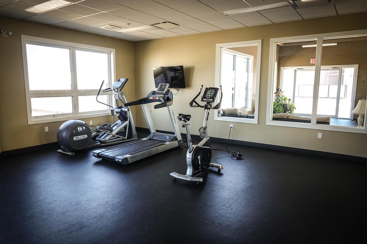 Two pieces of cardio equipment set up side by side in a home workout space